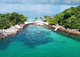Stunning aerial view of a tropical island in Angra dos Reis, Brazil, surrounded by turquoise ocean water.