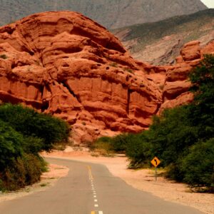 Winding road through Quebrada de las Conchas Canyon with stunning red rock formations.