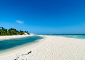 Breathtaking view of a pristine beach in Central Visayas, Philippines, under clear blue skies.